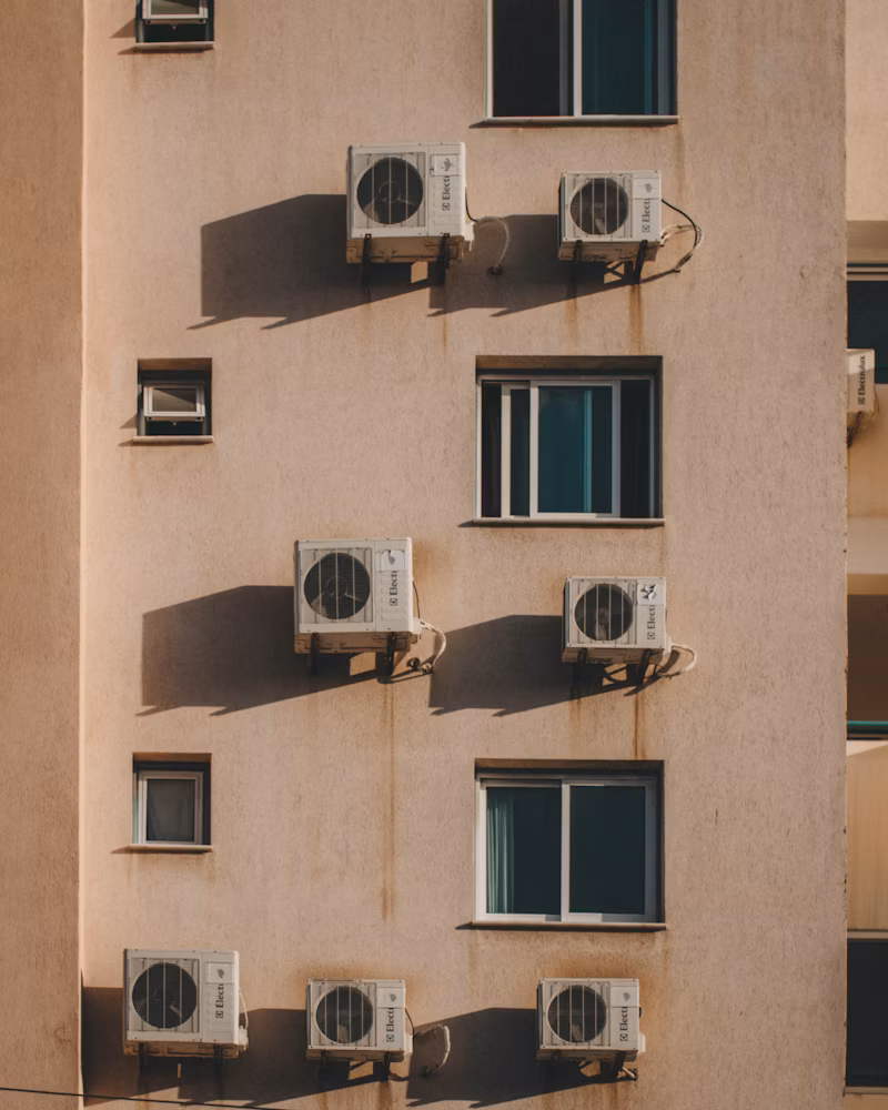 Outdoor AC units installed along the side of a building